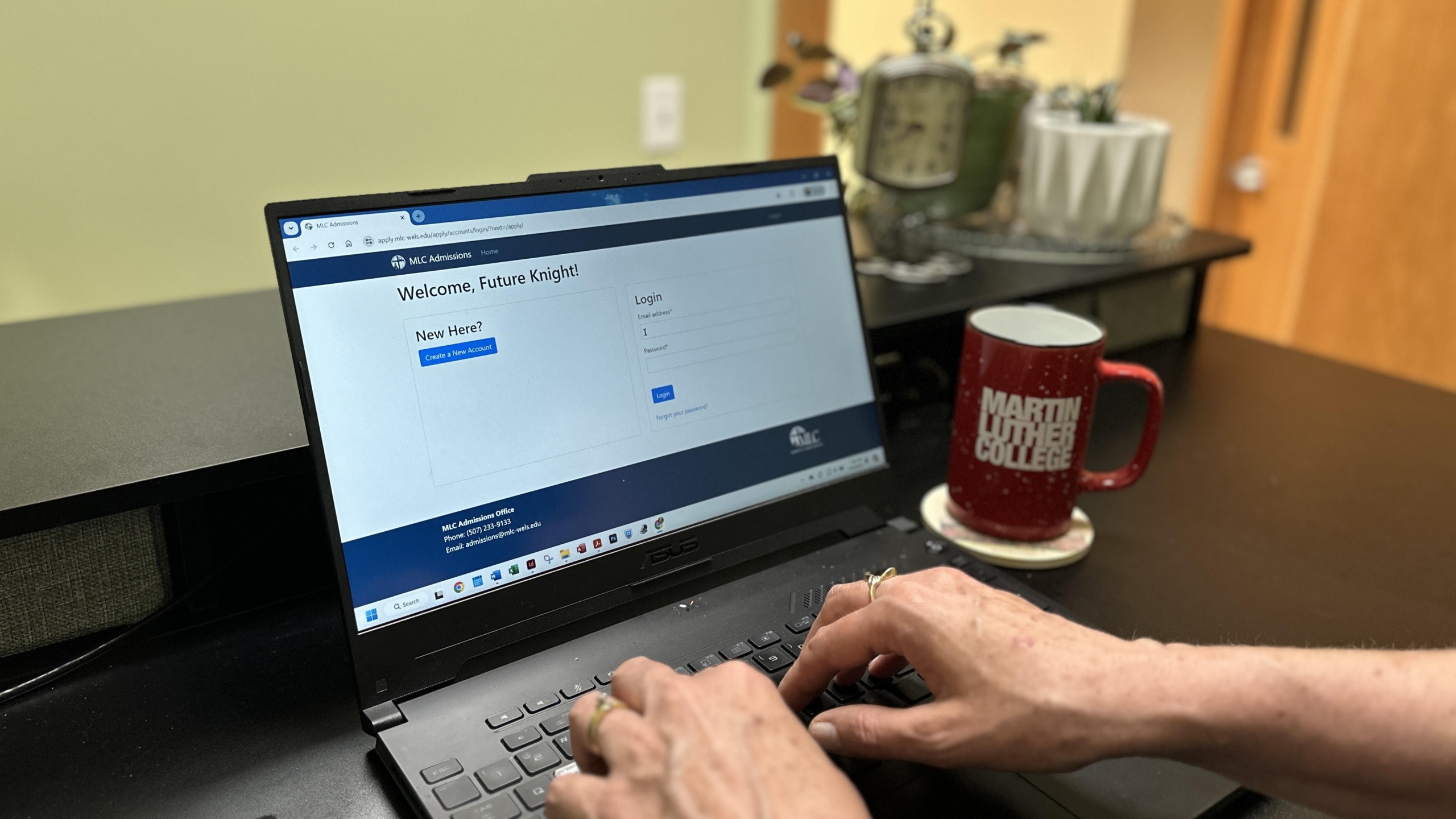 Hands typing on a laptop.