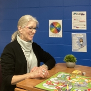 Gina Grove sitting at a game board