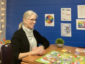 Gina Grove sitting at a game board