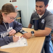 Josh Wong working with a student