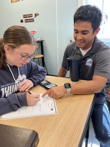 Josh Wong working with a student