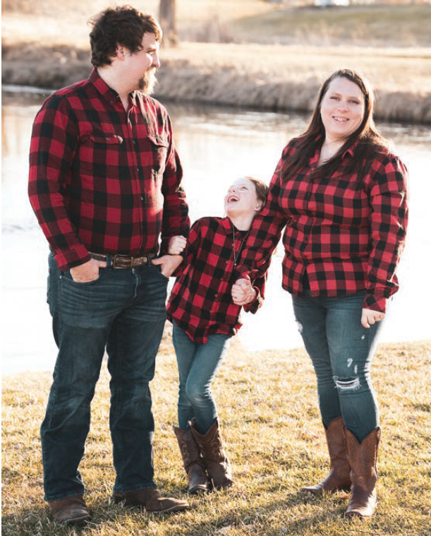 Harley Kujak with her husband, Tyler, and her daughter, Aria.