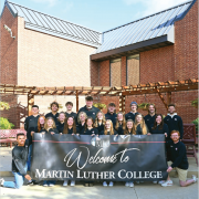 Students behind welcome sign