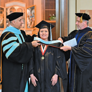 Master's graduate being hooded