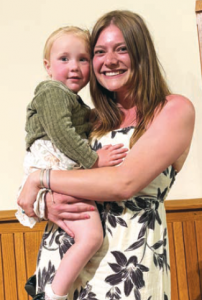Student posing with a child