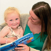Student reading to a children